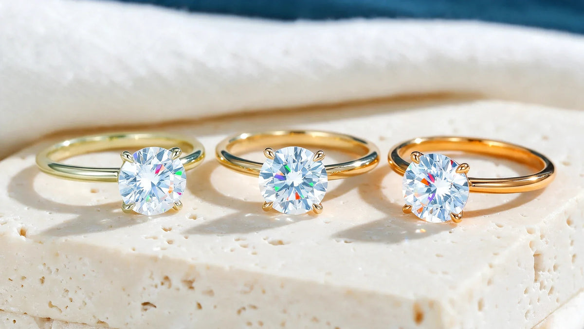 Three round solitaire rings in 10K, 14K and 18K yellow gold showing the color difference between karats (AI-generated editorial image)