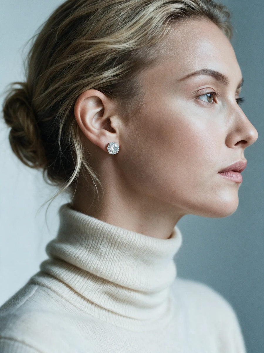 Woman wearing round lab grown diamond stud earrings